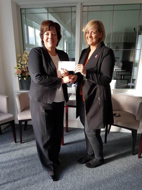Manager Nan Evans presenting the cheque to Debbie Rowley of Tenovus Cancer Care 